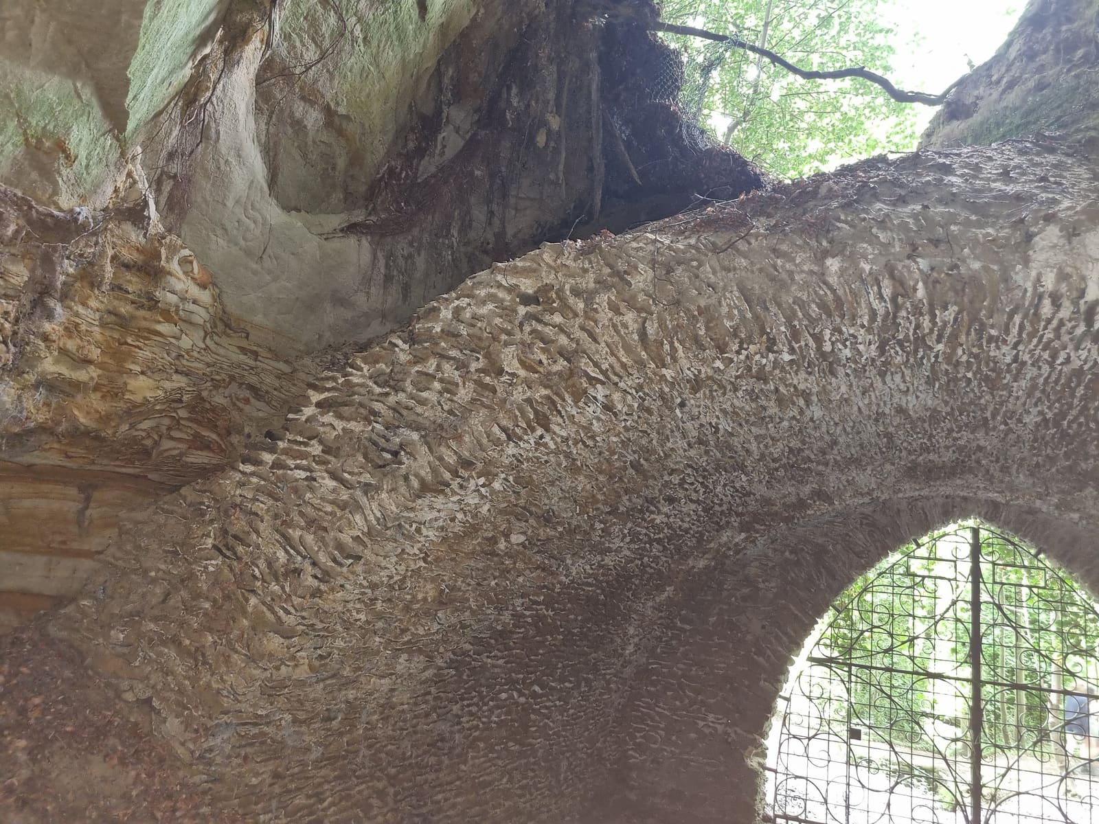 The sandstone roof above the gated entrance arch