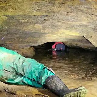 The cave entrance from the river path, spring 2024