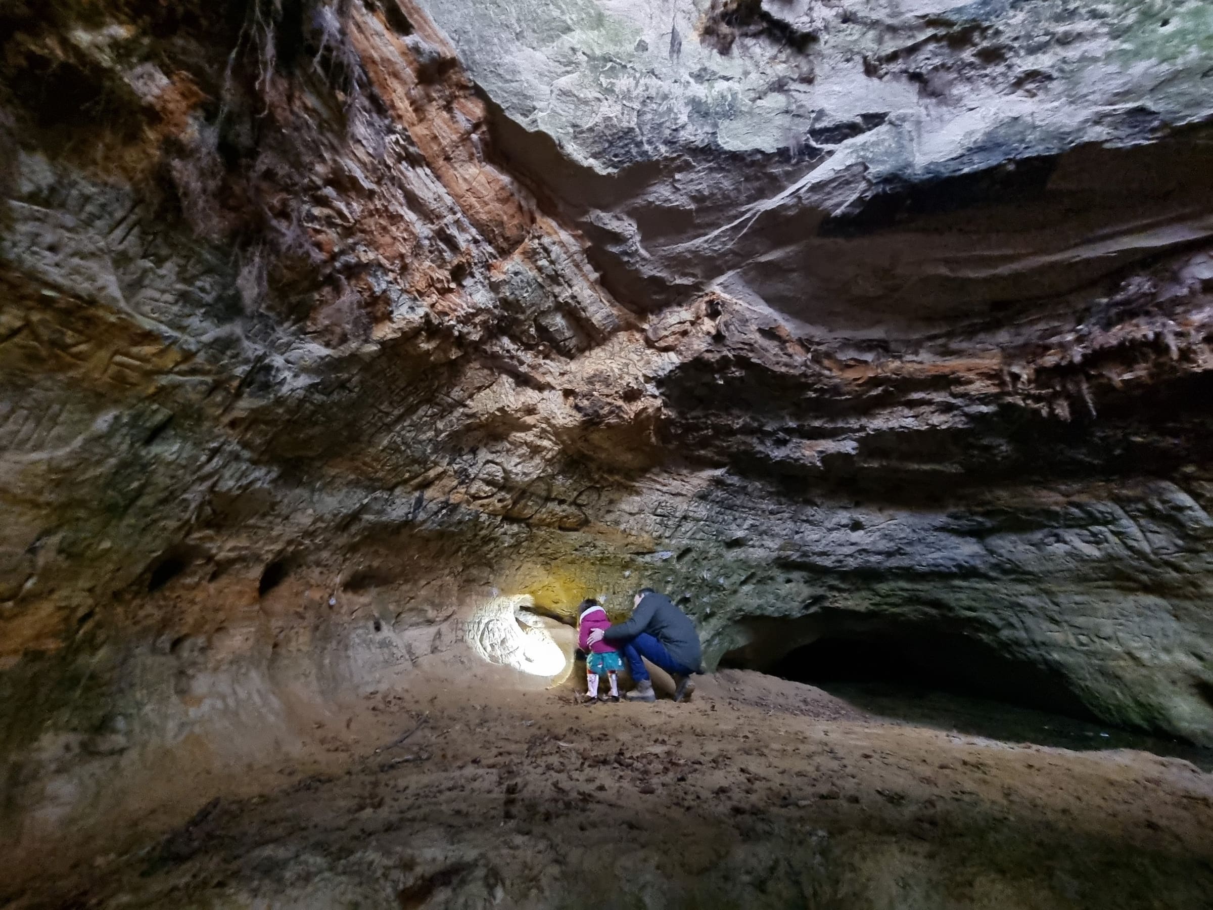 Exploring inside Mother Ludlam's Cave, light falling on the sandstone