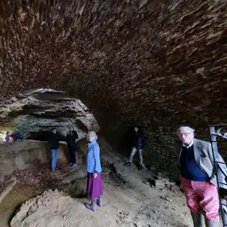A small group on a guided tour of the cave